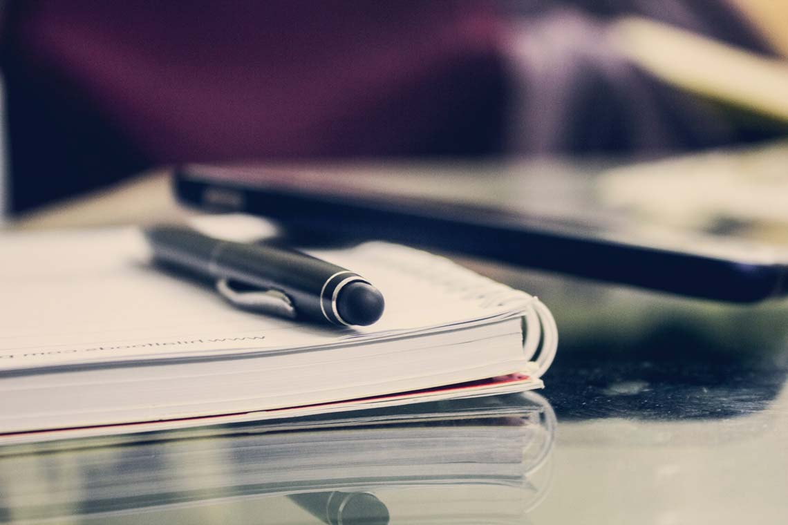black-twist-pen-on-notebook-891059-1